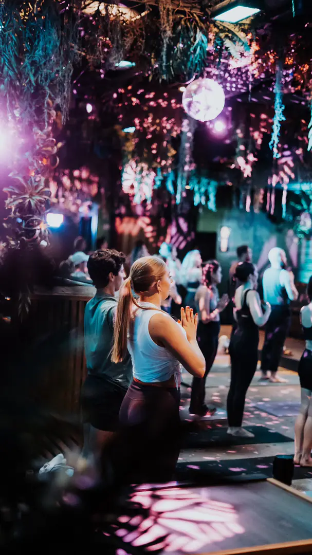 COBA yoga class under hanging florals and disco lights
